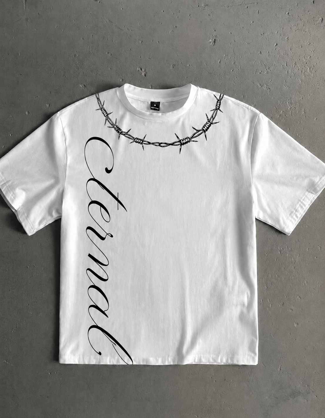 White oversized Eternal Structure t-shirt with a black barbed-wire collar graphic and vertical script down the left side