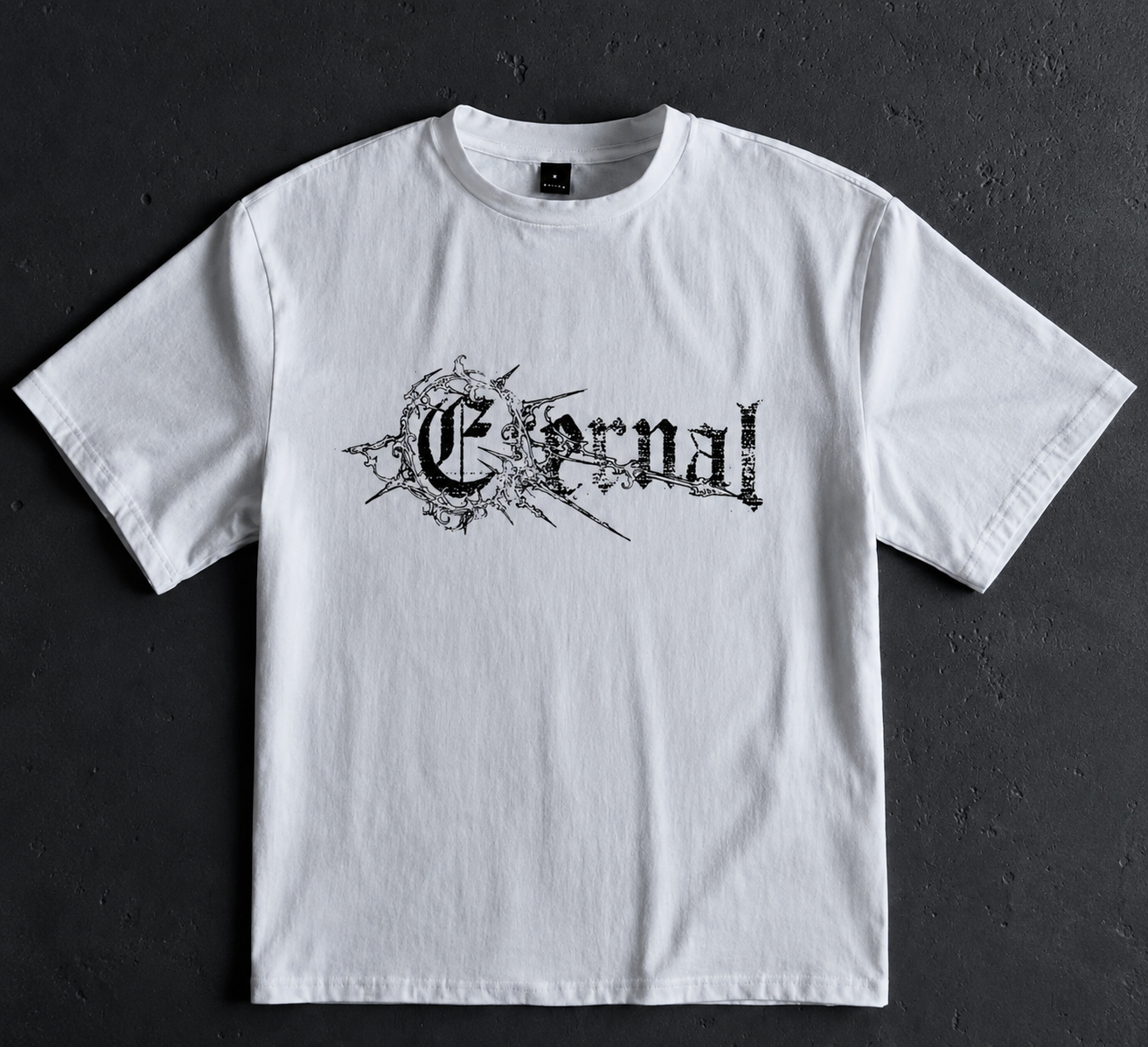 White oversized Eternal Structure emblem t-shirt photographed on a dark textured surface
